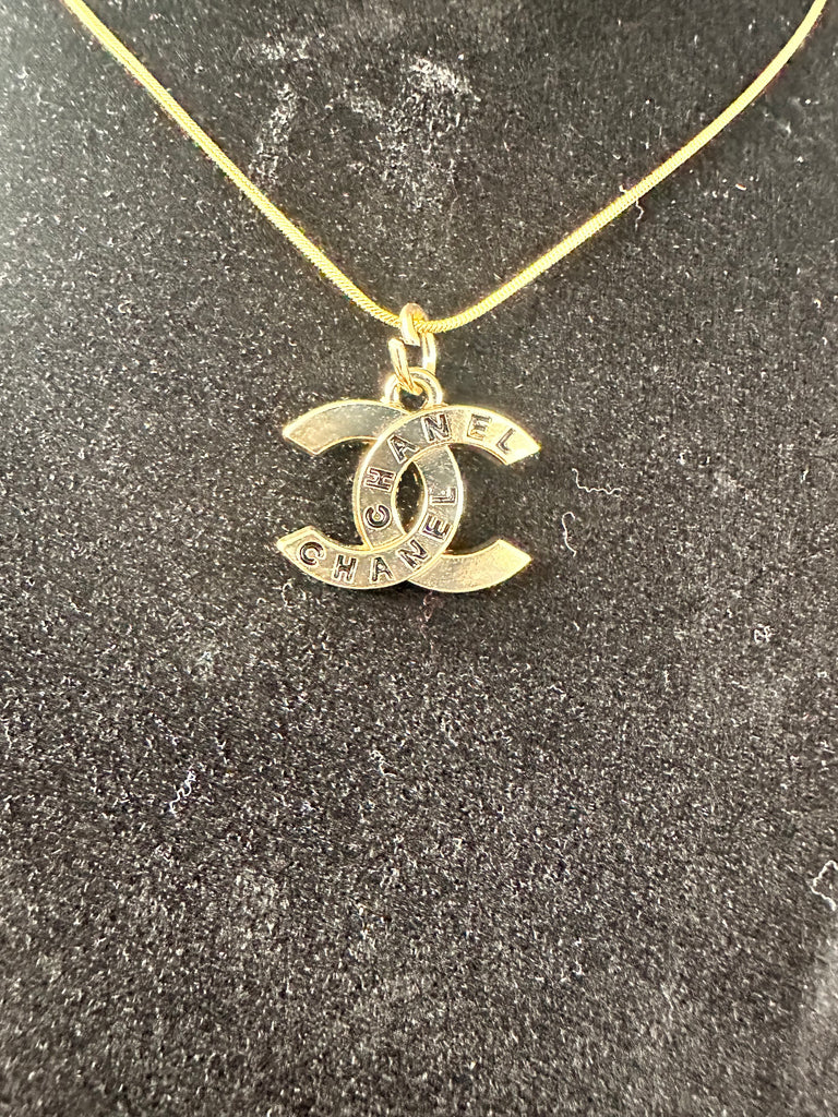 The “Gold & Black Script CC” Necklace