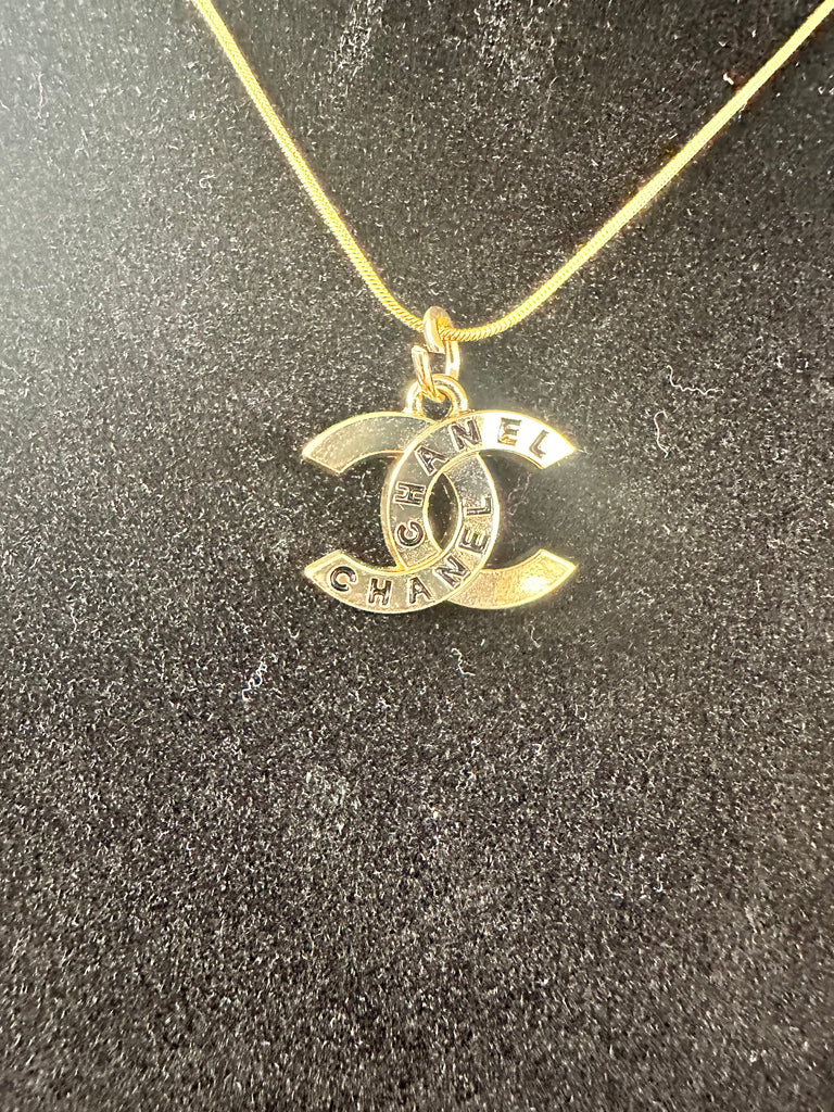The “Gold & Black Script CC” Necklace